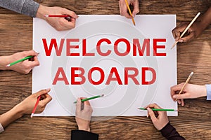 Businesspeople Hands Writing Welcome Aboard