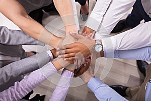 Elevated View Of Businesspeople Stacking Hands