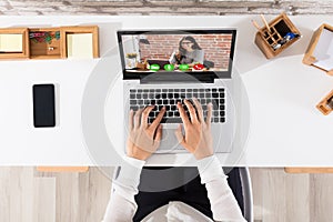 Elevated View Of Businessperson Videoconferencing On Laptop