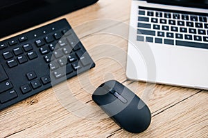 elevated view of computer keyboard, computer mouse and laptop