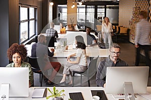 Elevated view of creative business colleagues working in a busy office