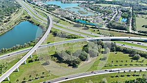 Elevated view of freeway exit junction over road lanes with fast moving traffic cars and trucks. Interstate