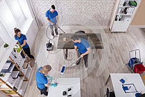 Elevated View Of Janitors Cleaning The Office