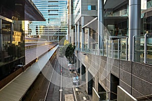 Elevated view of a laneway between modern buildings in the city. Background texture of roadway surrounded by business office photo