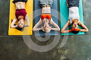 elevated view of multicultural female athletes exercising on fitness mats photo