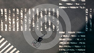 Elevated view over a biker man on pedestrian crossing in road intersection Japan