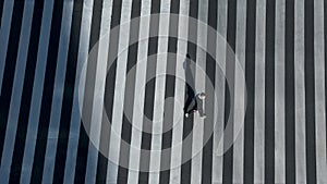 Elevated view over a man on pedestrian crossing in road intersection of Japan