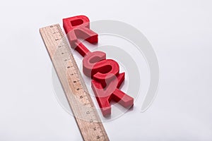 Elevated View Of Red Risk Word And Wooden Ruler