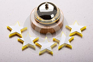 Elevated View Of Service Bell And Five Star Rating Icon