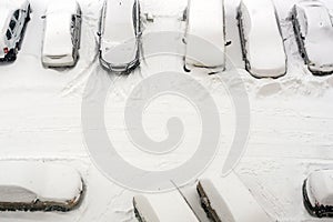 Elevated view of snow covered cars in parking lot