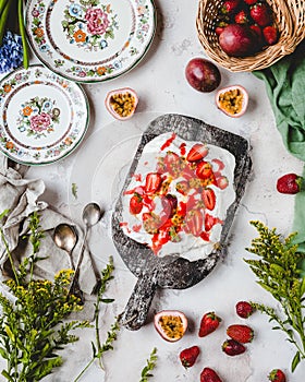 elevated view of tasty strawberry and passion fruit meringue cake