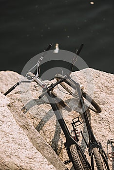 elevated view of two mountain bicycles on rocky cliff