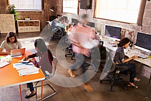 Elevated View Of Workers In Busy Modern Design Office