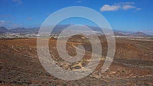 Elevated views of the arid volcanic landscape surrounding the summit of Montana Amarilla, Costa del Silencio, Tenerife, Spain photo