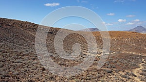 Elevated views of the arid volcanic landscape surrounding the summit of Montana Amarilla, Tenerife, Canary Islands, Spain photo