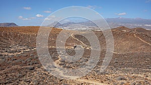 Elevated views of the arid volcanic landscape surrounding the summit of Montana Amarilla, Costa del Silencio, Tenerife, Spain photo