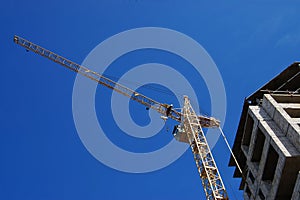 Elevating crane against the dark blue sky