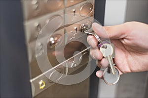 Elevator access control. hand holding a key to unlock elevator floor