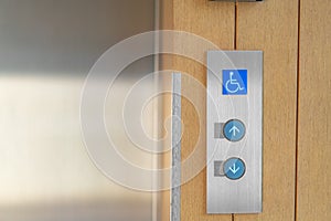 Elevator buttons with Braille codes and handicap sign. Allow signs for up and down
