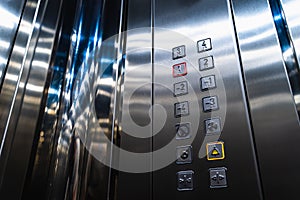 Elevator Buttons for Disabled Blind People with Braille Language Signs on Panel photo