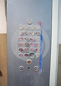 Elevator control panel with numbered floor buttons.