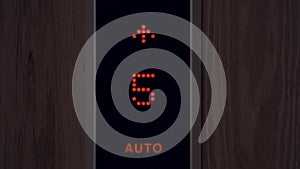 Elevator numbers on a black background. Changing numbers and a moving elevator panel to different floors in a high-rise