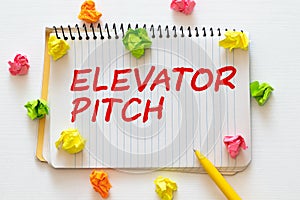 elevator pitch text message on white paper and office supplies, pen, paper note, on white desk