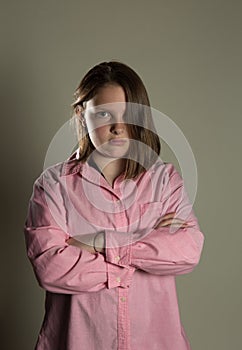 Eleven year old girl in oversized pink blouse