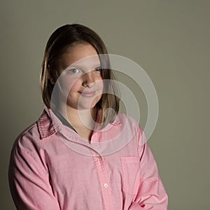 Eleven year old girl in oversized pink blouse