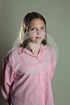 Eleven year old girl in oversized pink blouse