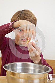 Eleven years old boy opening an egg