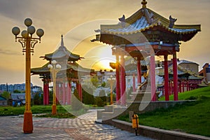 Buddhist pavilions in the Golden Abode temple in Elista at sunset photo