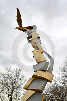 ELISTA, RUSSIA. A street sculpture of a golden eagle with a soccerball about an entrance on Uralan stadium. Kalmykia