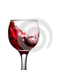 Elite alcoholic drink red wine splashing in a glass with grapes