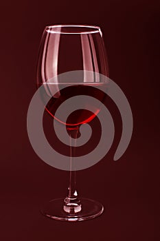 Elite red wine in glass on red background.