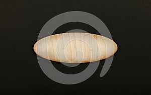 Ellipse shaped wooden sign on black background