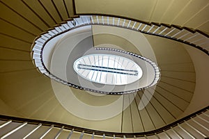 An elliptic staircase winding down an old building - 1
