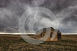 Ellis County, KS USA - Abandoned Limestone Farmhouse in the Midwest Prairie under Tempestuous Skies