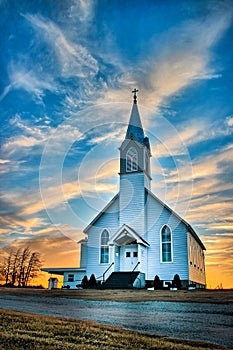 Ellis County, KS USA - A Lone Wooden Church at Dusk with Sunset Clouds in Kansas American Midwest Prairie