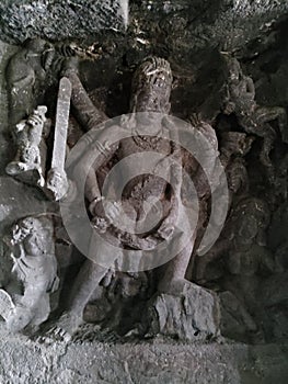 Ellora caves rock cutting temple statue of lord shiva with weapon