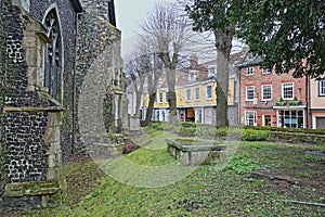 Elm Hill cobbled street with medieval houses from the Tudor period with St Simon and St Jude Chuch on the left