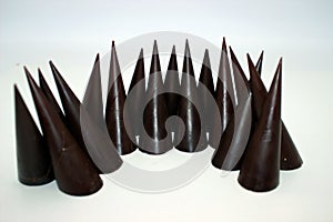 Elongated chocolates on white background