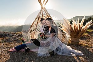 Elopement wedding in the mountains, rock and roll style. couple, teepee, sunset photo