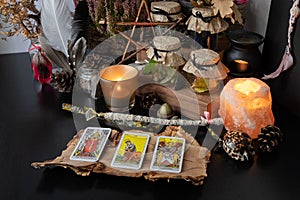 Elva/Estonia - 31 August 2020 - 3 Tarot Rider Waite cards spread lying on a black table with magic items