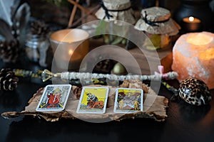 Elva/Estonia - 31 August 2020 - 3 Tarot Rider Waite cards spread lying on a black table with magic items