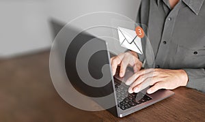 Email or electronic mail concept. A man uses computer laptop to send and receive online messages with email inbox icons, email