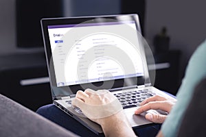 Email inbox on laptop screen. List of messages. Man checking received e mail. Spam, junk and digital marketing. Read, reply.