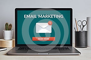 Email marketing concept on laptop screen on modern desk