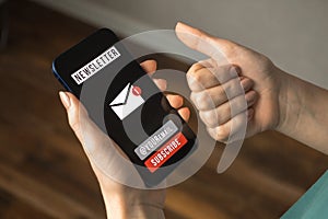 Email marketing and media, communication with newsletter concept background. Mobile phone with signup newsletter page