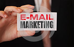 Email marketing words on card a businessman shows. Business strategy client oriented concept